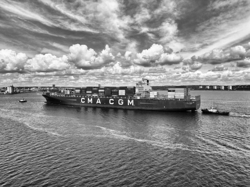 Monochrome photo of a container ship at sea port