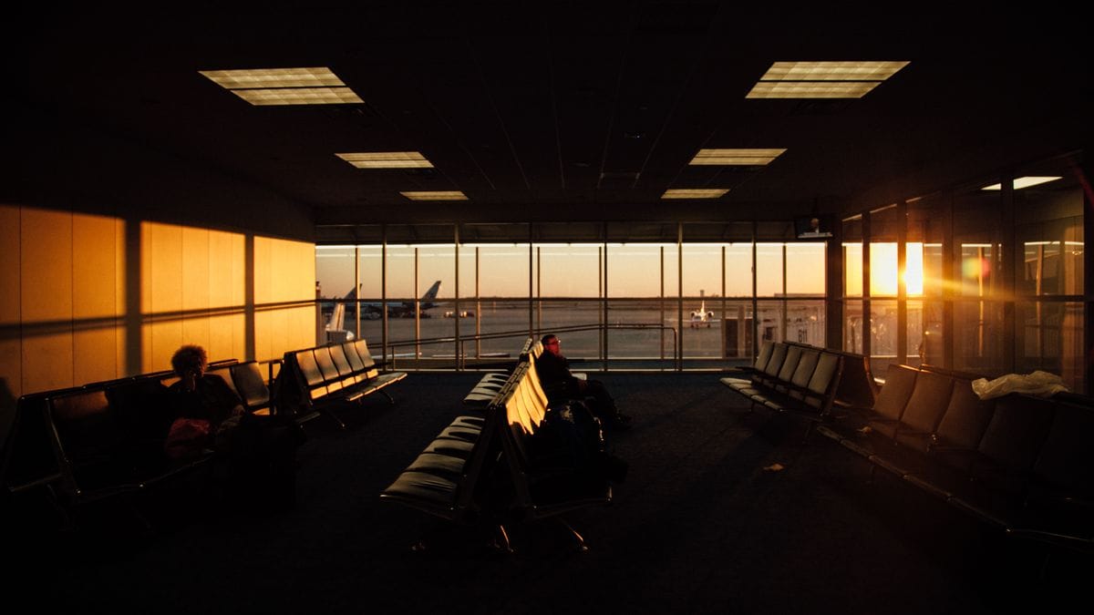 Peaceful airport waiting area with sunset silhouettes and quiet ambiance.